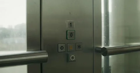 A woman presses a button in the elevator Stock Footage 269027176