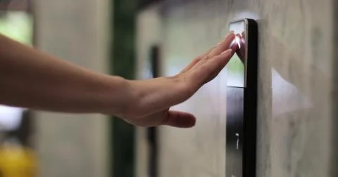 Woman presses the elevator button in office center or hotel. Elevator door Fotos de archivo