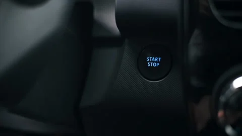 Woman presses the engine start button in the car. Slow motion Stock Footage 196959872