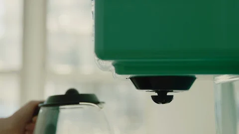 Woman pressing button on coffee machine to make coffee Stock Footage 130089206