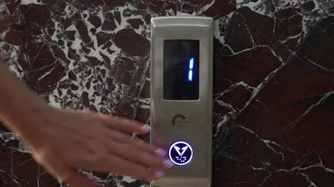 Woman pressing button of elevator lift in corridor of building Video stock 194491306