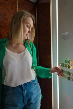 Woman pressing button inside the elevator. Foto stock