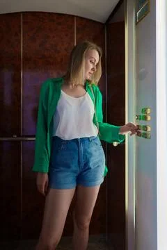 Woman pressing button inside the elevator. Foto stock