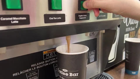 Woman pressing a coffee machine button at 7 eleven 스톡 동영상 280293701