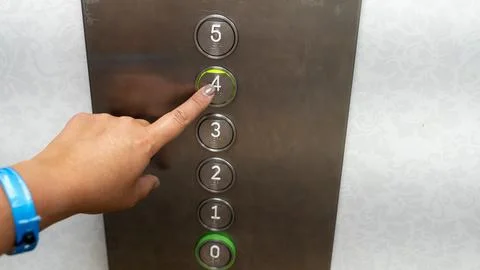 Woman Pressing Elevator Button for Fourth Floor Close Up Stock Photos