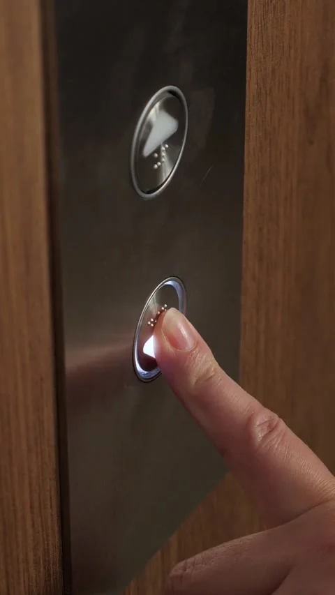 Woman pressing the elevator button to go down Stock Footage 341440499