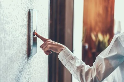 Woman pressing the elevator button with index finger Foto stock