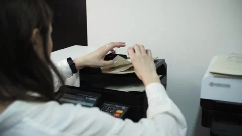 Woman printing documents on a printer Stock Footage 301601656