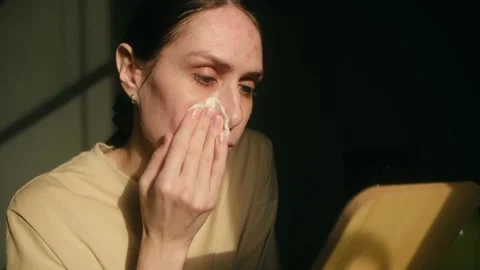 Woman with problem skin applying cleanser with cotton pad Stock Footage 323896706
