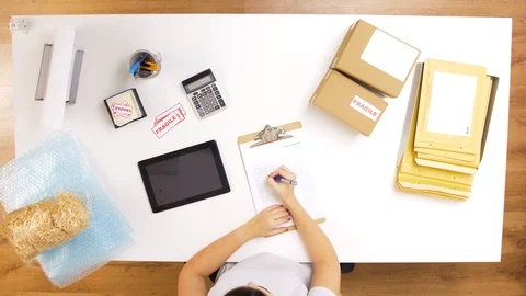 Woman processing fragile parcels at post office Stock Footage 102459757