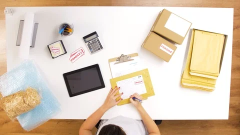 Woman processing fragile parcels at post office Stock Footage 102570469