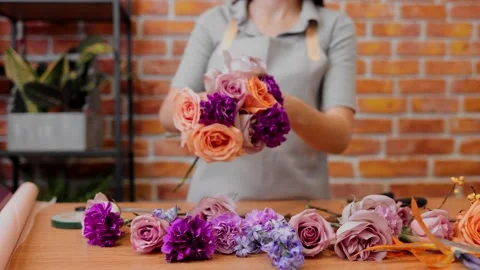 Woman professional makes bouquet. Slow motion. Close up young female florist in Stock Footage 166364145