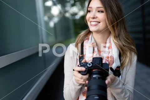 Woman is a professional photographer with dslr camera, outdoor and sunlight Stock Photos
