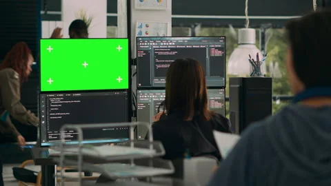 Woman programer looking at greenscreen and code on terminal window Stock Footage 217409513