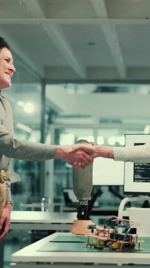 Woman, programmer and shaking hands at lab for robotics with smile, coding and 스톡 동영상 332912711
