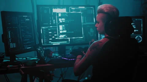 Woman programmer corrects coding error on computer monitors Stock Footage 257815674