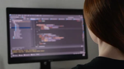 Woman programmer is typing code or typing an application Stock Footage 154367625