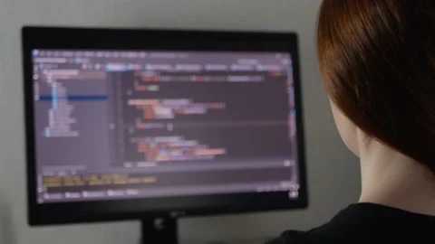 Woman programmer is typing code or typing an application Stock Footage 154367691