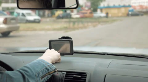 Woman programs the GPS navigator on the windshield Stock Footage 63621653