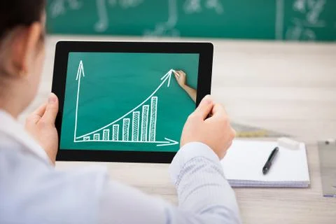 Woman with progress chart on digital tablet Stock Photos