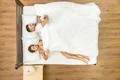 The woman pull a blanket on the bed. View from above Photo