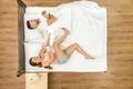 The woman pull a blanket on the bed. View from above Photo