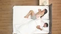 The woman pull duvet near man on the bed. view from above 4k or 4k+ Resolution