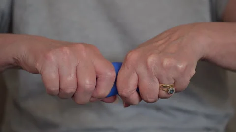 Woman Pulling Blue Physiotherapy Putty for Broken Arm Rehabilitation Stock Footage 345250587