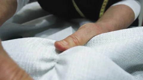 Woman pulling the thread to cut the fabric straight Stock Footage 106757515