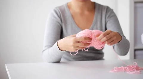 Woman pulling yarn up into ball Video stock 68969989