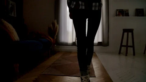 Woman pulls back the curtains of the window 動画素材 86595242