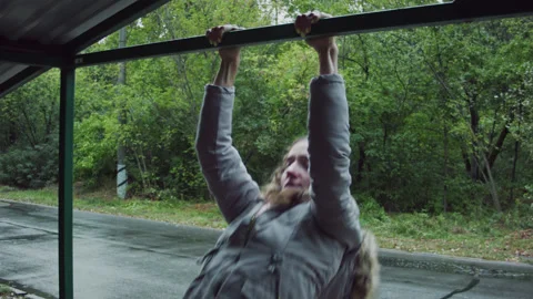 A woman pulls herself up in the forest. 스톡 동영상 139088275