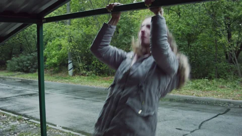 A woman pulls herself up in the forest. 스톡 동영상 139088628