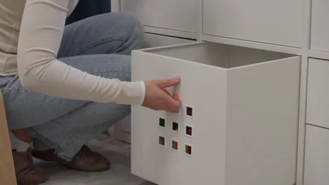Woman Pulls Open White Modular Storage Box to Tidy Away Clutter. 動画素材 320711410