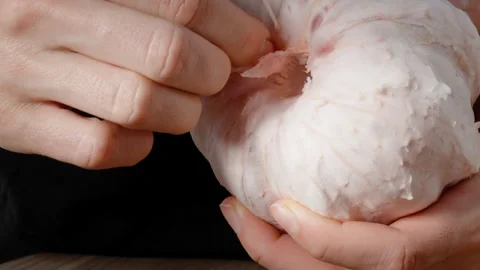 A woman pulls out the core inside the pomelo to clean it. Stock Footage 263726331