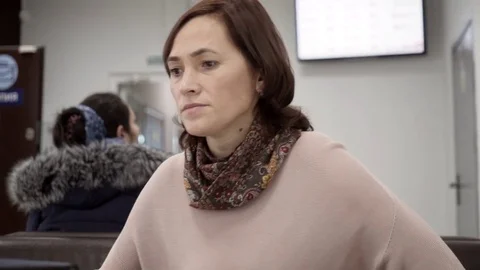 A woman pulls out documents from the folder. Business woman sitting on sofa Stock Footage 81767540