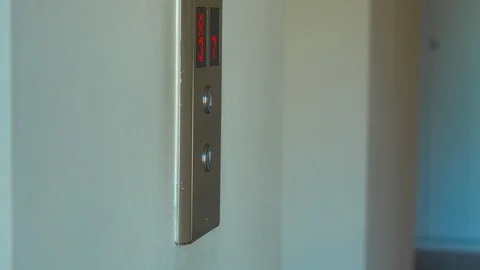 Woman push the button to call an elevator and then enters inside Stock Footage 88273969