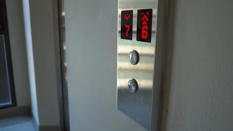 Woman push the button to call an elevator and enter inside Stock Footage 88281616