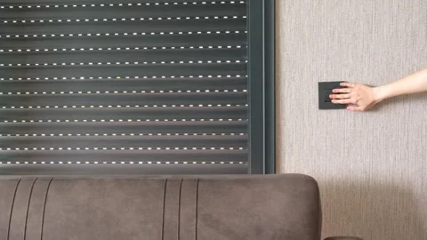 Woman push switch button of automatic roller shutter close the window at mo.. 库存影片 243393794