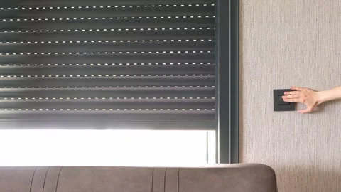 Woman push switch button of automatic roller shutter open the window at mor.. Stock Footage 243393961