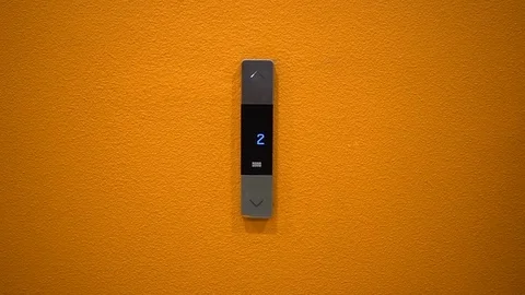 A woman pushes an elevator button for a down closeup Stock Footage 78304570