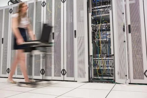 Woman pushing computer through data center Stock Photos