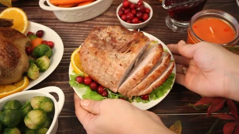 Woman put on the table ham for festive Christmas or Thanksgiving day. Stock Footage 143012808