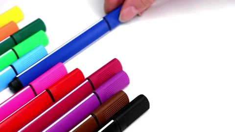 The woman puts a blue marker on the stack of colored markers. Stock Footage 157766274