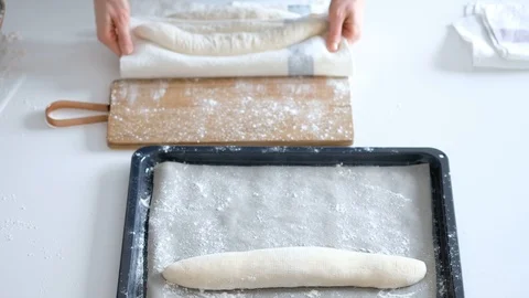 Woman puts the bread in baking sheet. Bread. 4K Stock Footage 121527491