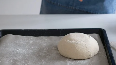 Woman puts the bread in baking sheet. Bread. 4K Stock Footage 128255823
