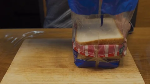 Woman puts bread on a table Stock Footage 102982516