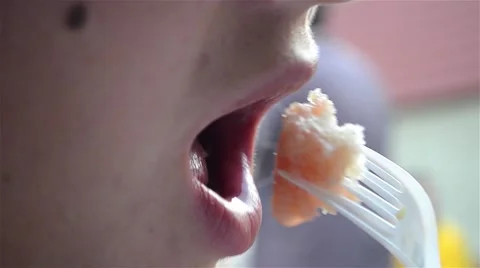 Woman puts a core bread with a fork dipped in tomato juice Stock Footage 64348272