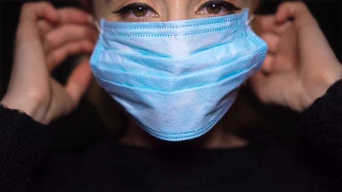 Woman Puts On Face Mask Virus Flu Pneumonia Coronavirus Epidemic Pandemic Stock Footage