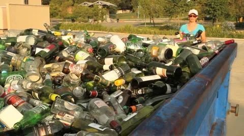 Woman puts Glass Bottles into Recycling Container GFHD Stock Footage